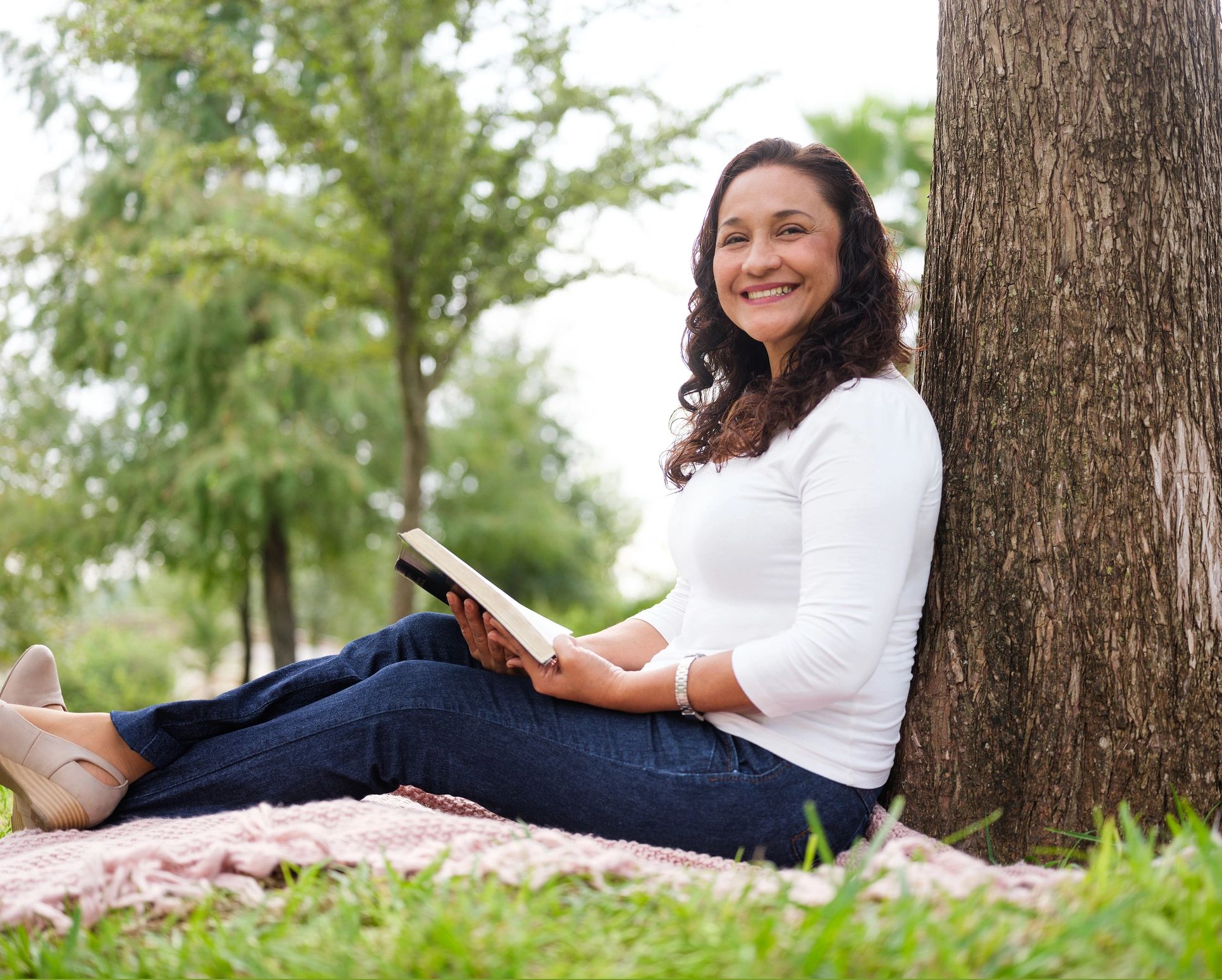 Woman holding a Bible outdoors